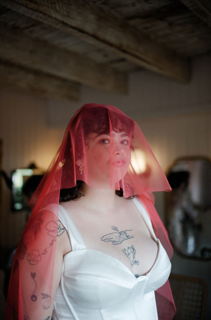 Alt bride wearing pink veil.