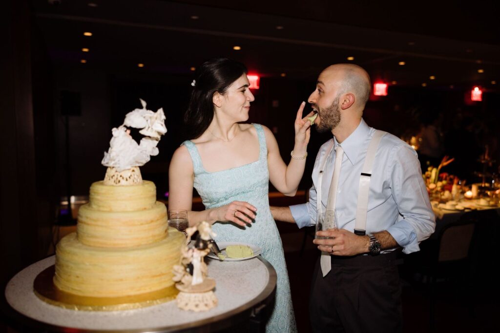 Bride feeding cake to groom, photographed by Documentary Wedding Photographer, Daniel Silbert.